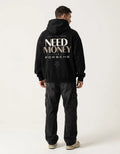 Model wearing a minimalist black Porsche graphic hoodie with oversized neutral lettering and motivational back print