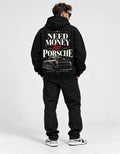 Male model wearing black vintage racing hoodie with Need Money for Porsche back graphic and car illustration