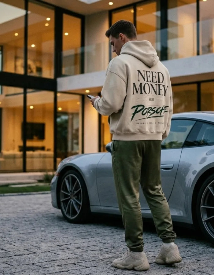Cream Need Money for Porsche hoodie with charcoal serif lettering, forest-green brush script and a subtle tonal sports car outline on the back