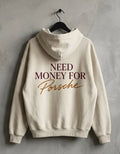 Cream Need Money for Porsche hoodie hanging on a black hanger with burgundy serif lettering and gold handwritten Porsche back print