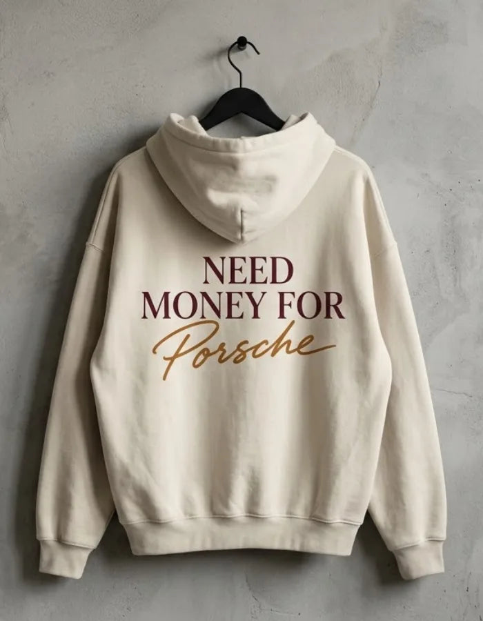 Cream Need Money for Porsche hoodie hanging on a black hanger with burgundy serif lettering and gold handwritten Porsche back print