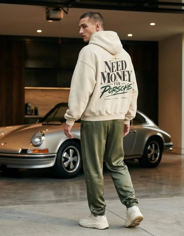 Cream Need Money for Porsche hoodie with dark serif lettering, forest-green brush script, gold star and Dreams Fuel Progress back print
