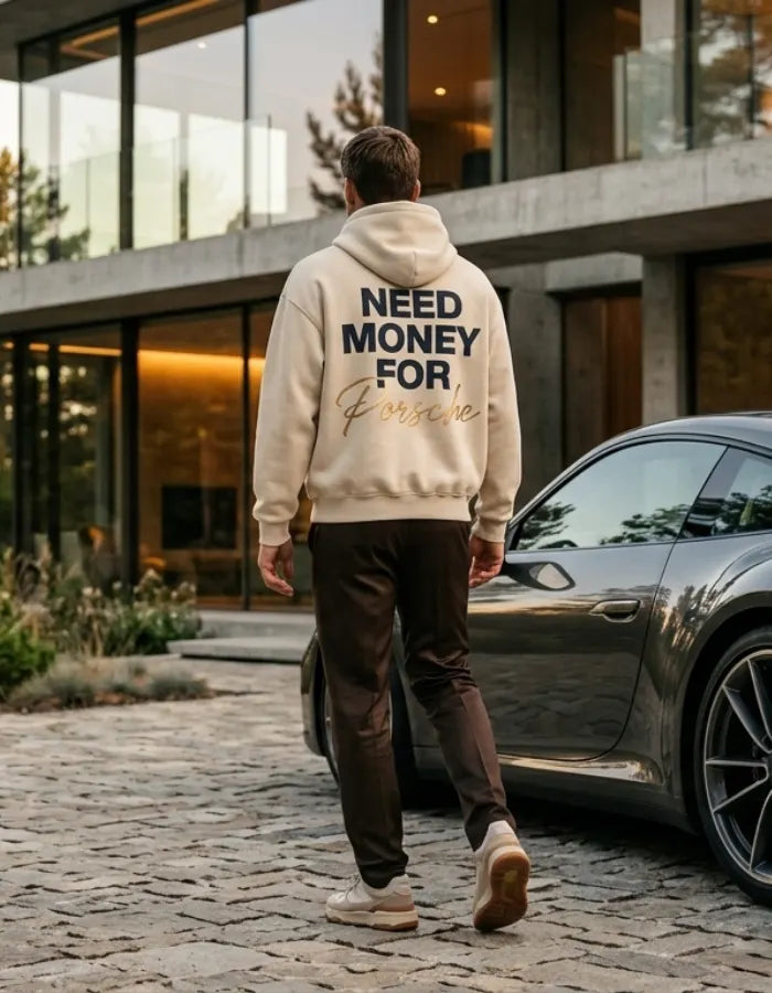 Model wearing a cream Porsche graphic hoodie from behind with stacked navy typography and large gold handwritten Porsche lettering