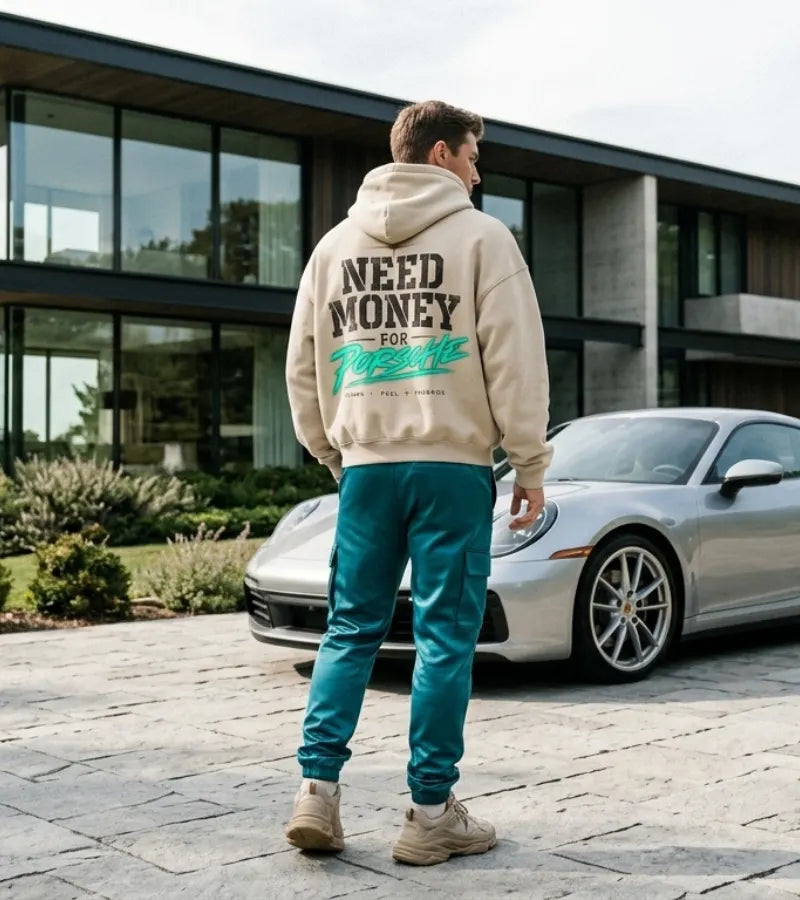 Cream Need Money for Porsche hoodie with distressed charcoal lettering, vibrant mint-green brush script, gold star and Dreams Fuel Progress back print