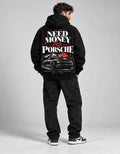 Male model wearing black Need Money for Porsche hoodie with mountain sunset car graphic on the back