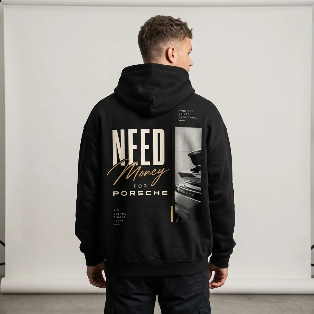 Model wearing a black Porsche graphic hoodie with cream NEED lettering, gold Money script and vertical automotive photo print