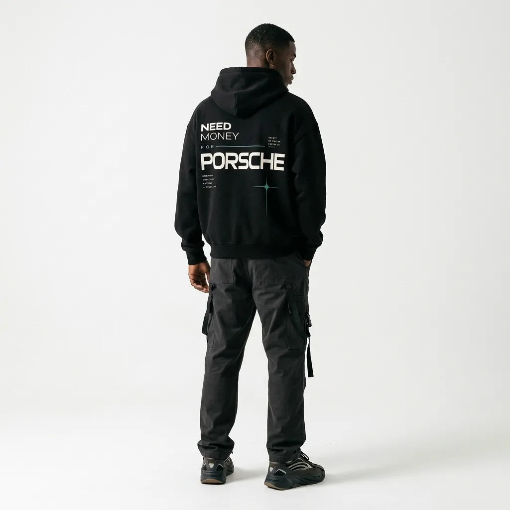 Model wearing a black Porsche graphic hoodie with modern white lettering, mint green line details and a four-point star back print