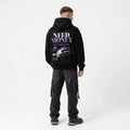 Model wearing a black Porsche graphic hoodie with purple MONEY typography, sports car rear-wing photograph and geometric back print