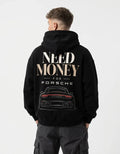 Model wearing a black Porsche-inspired graphic hoodie with oversized Need Money typography and detailed sports car back print
