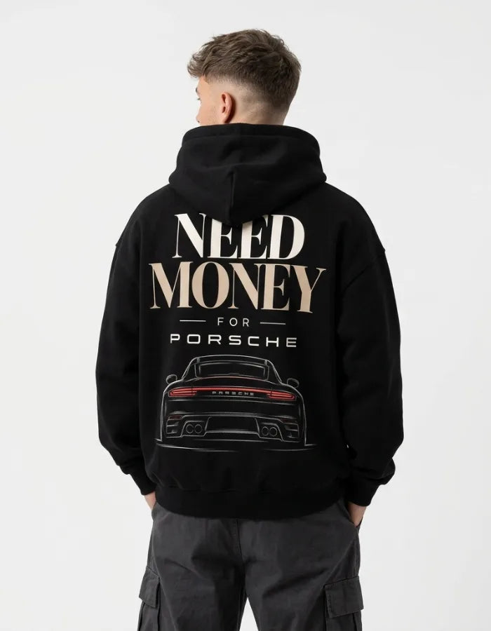 Model wearing a black Porsche-inspired graphic hoodie with oversized Need Money typography and detailed sports car back print